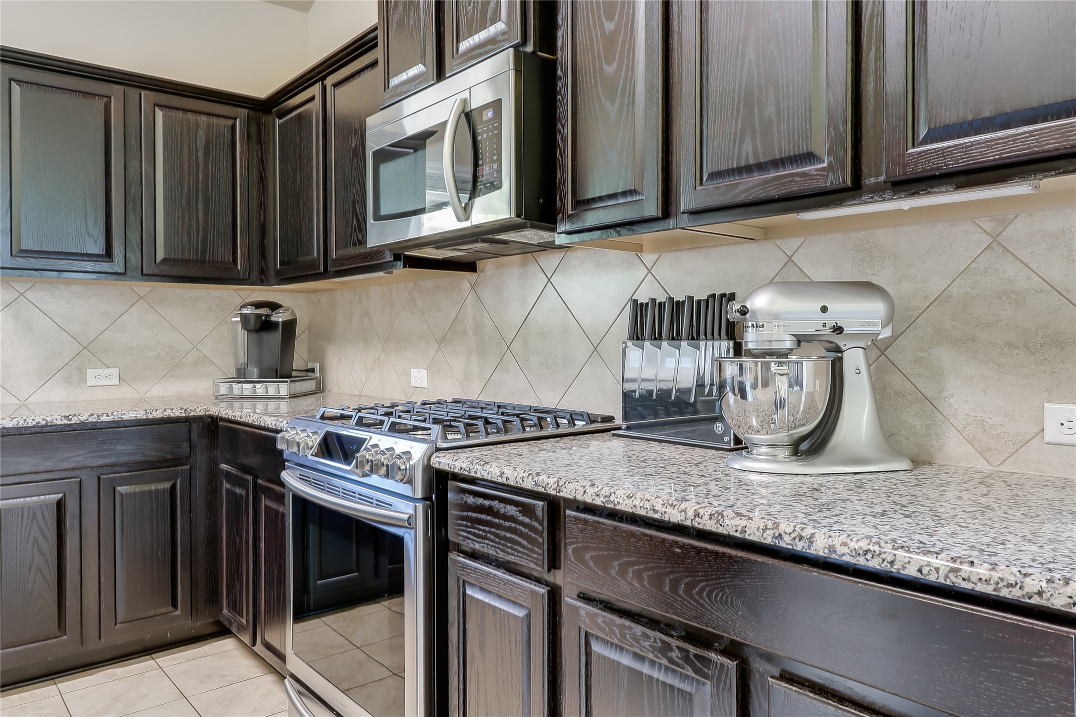 1425 Hamiltons Way Leander, TX 78641 - Photo 21 of 38 a kitchen with stainless steel appliances granite countertop a sink stove and microwave