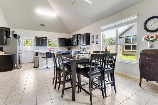 a view of a dining room with furniture and a kitchen