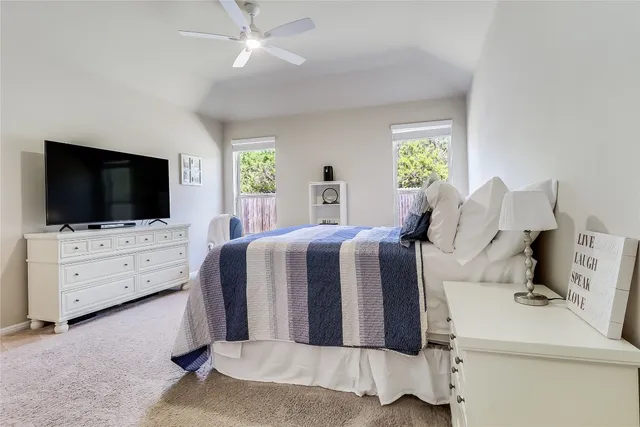 a bed room with furniture and flat screen tv