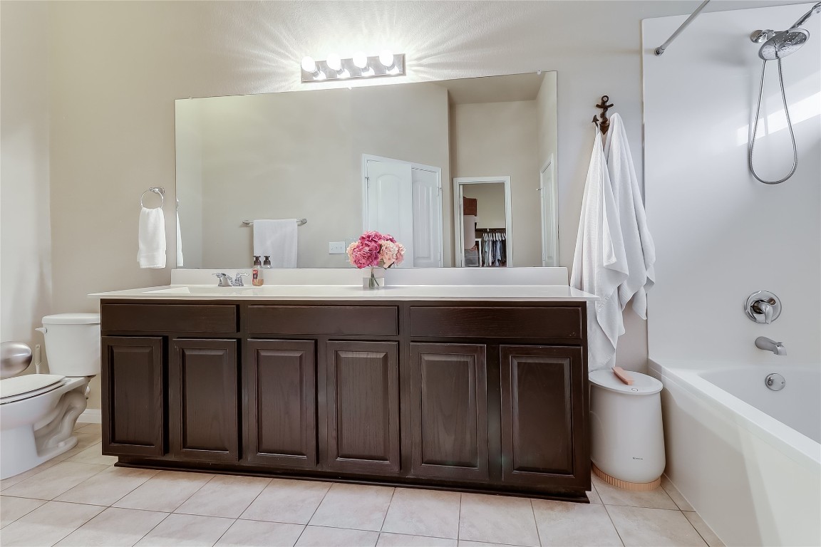 1425 Hamiltons Way Leander, TX 78641 - Photo 30 of 38 a bathroom with a sink and a mirror