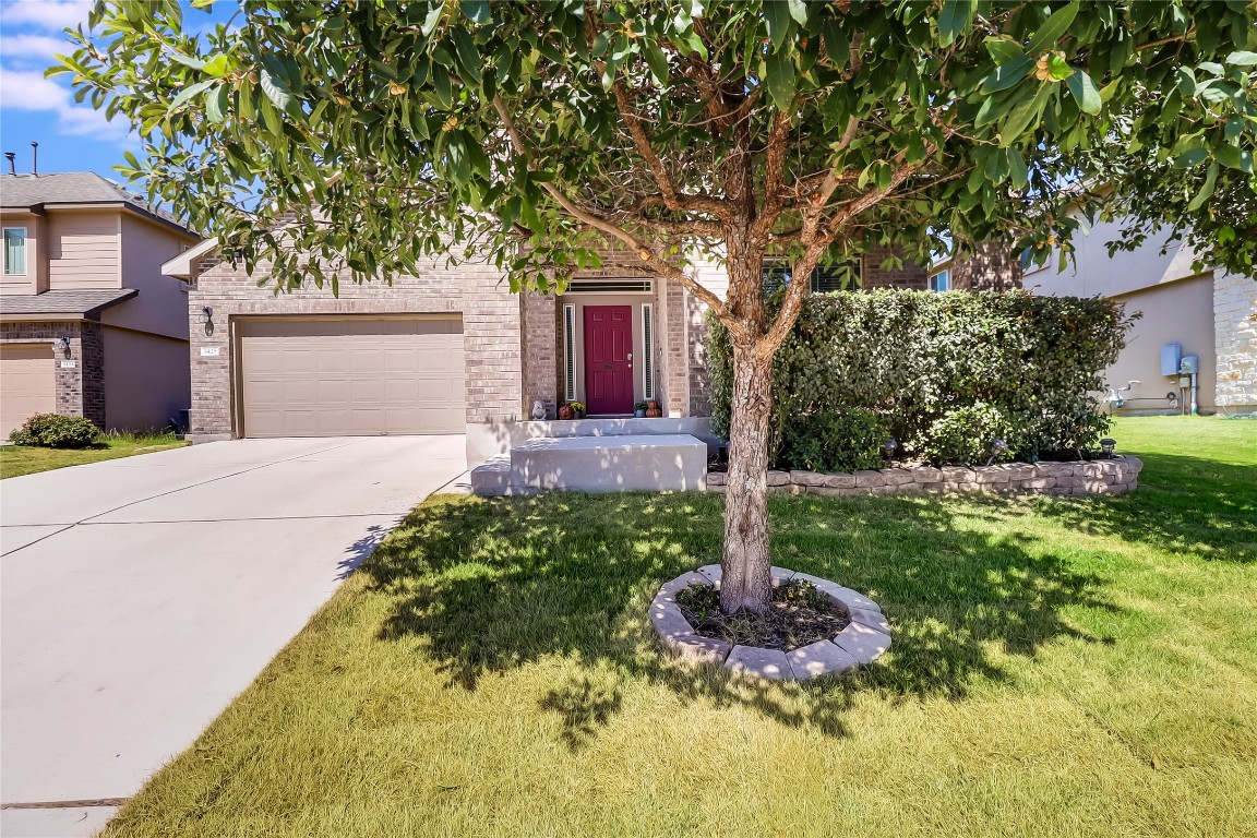 1425 Hamiltons Way Leander, TX 78641 - Photo 33 of 38 a front view of a house with a yard and fountain