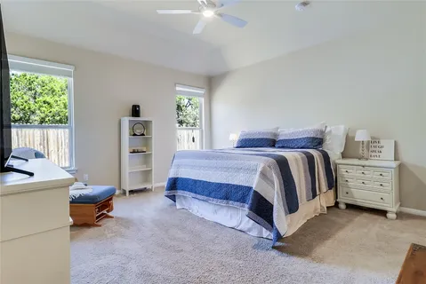 a bedroom with a bed and a chair