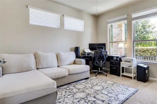 a living room with furniture rug and window