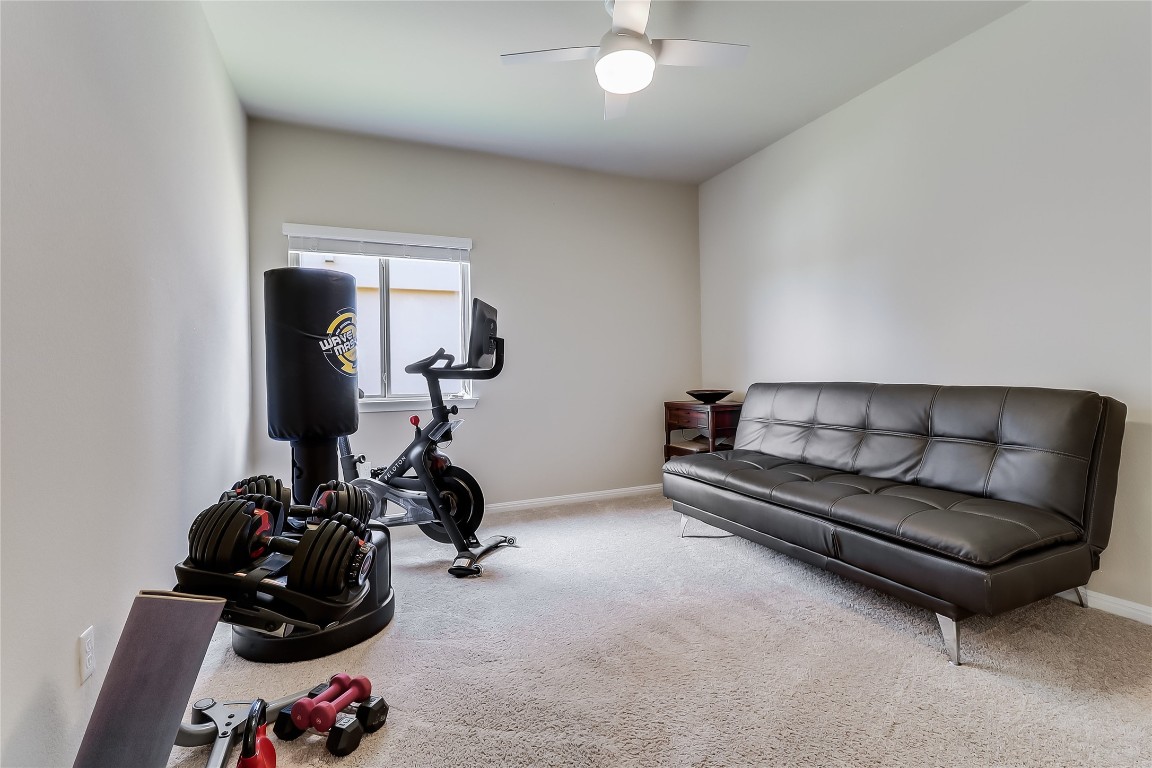 1425 Hamiltons Way Leander, TX 78641 - Photo 10 of 38 a room with gym equipment and a mirror