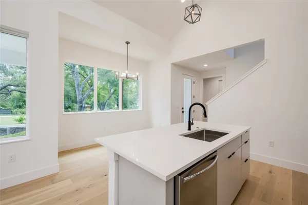 a kitchen with a sink a counter top space and a window
