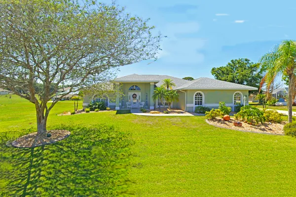 a front view of house with yard swimming pool and outdoor seating