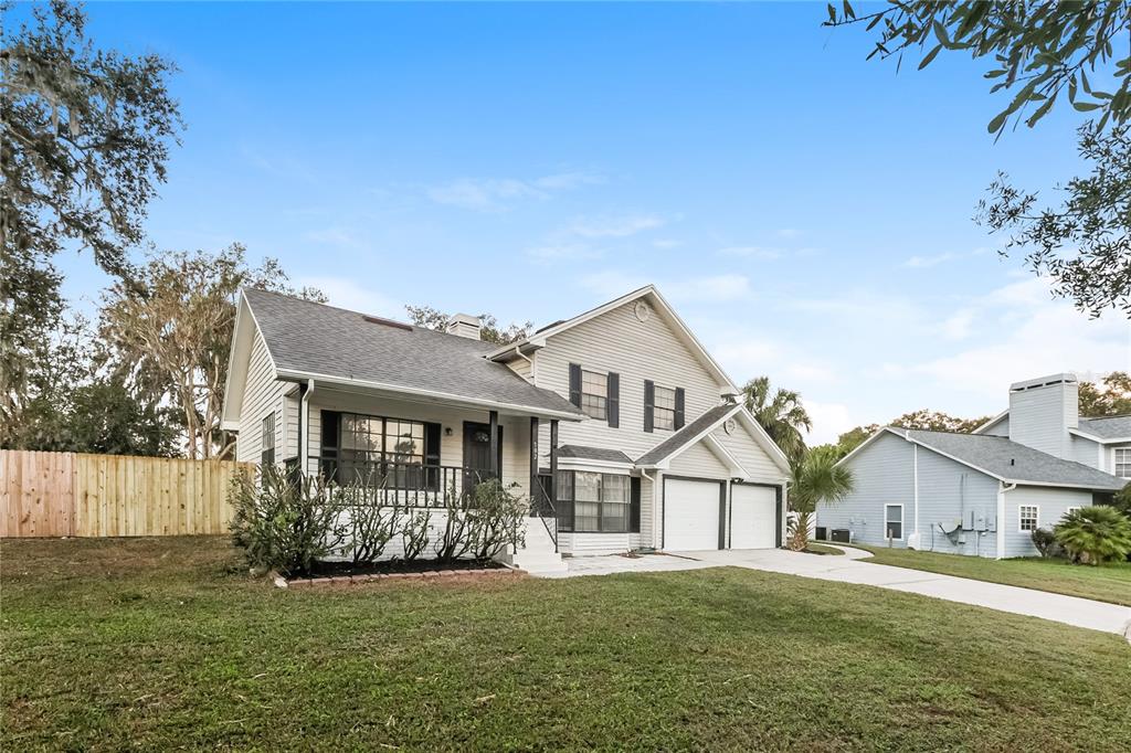 702 Old Darby Street Seffner, FL 33584 - Photo 1 of 1 a front view of a house with a yard