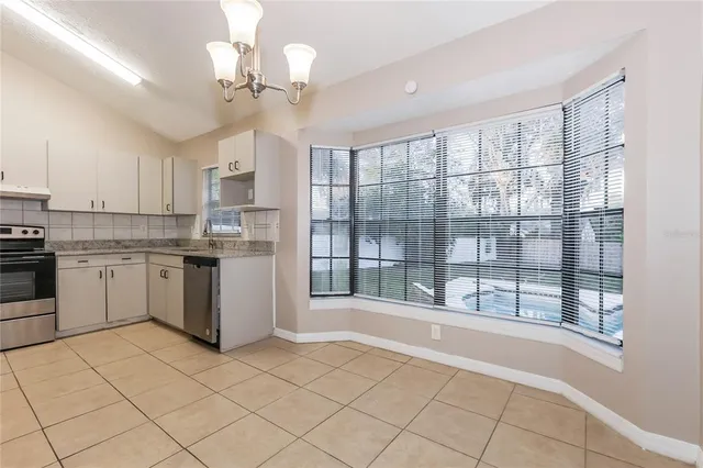 a kitchen with stainless steel appliances granite countertop a stove sink and cabinets