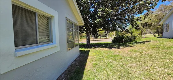 a view of a park with trees in the background