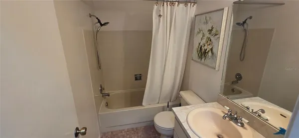 a white toilet sitting next to a sink