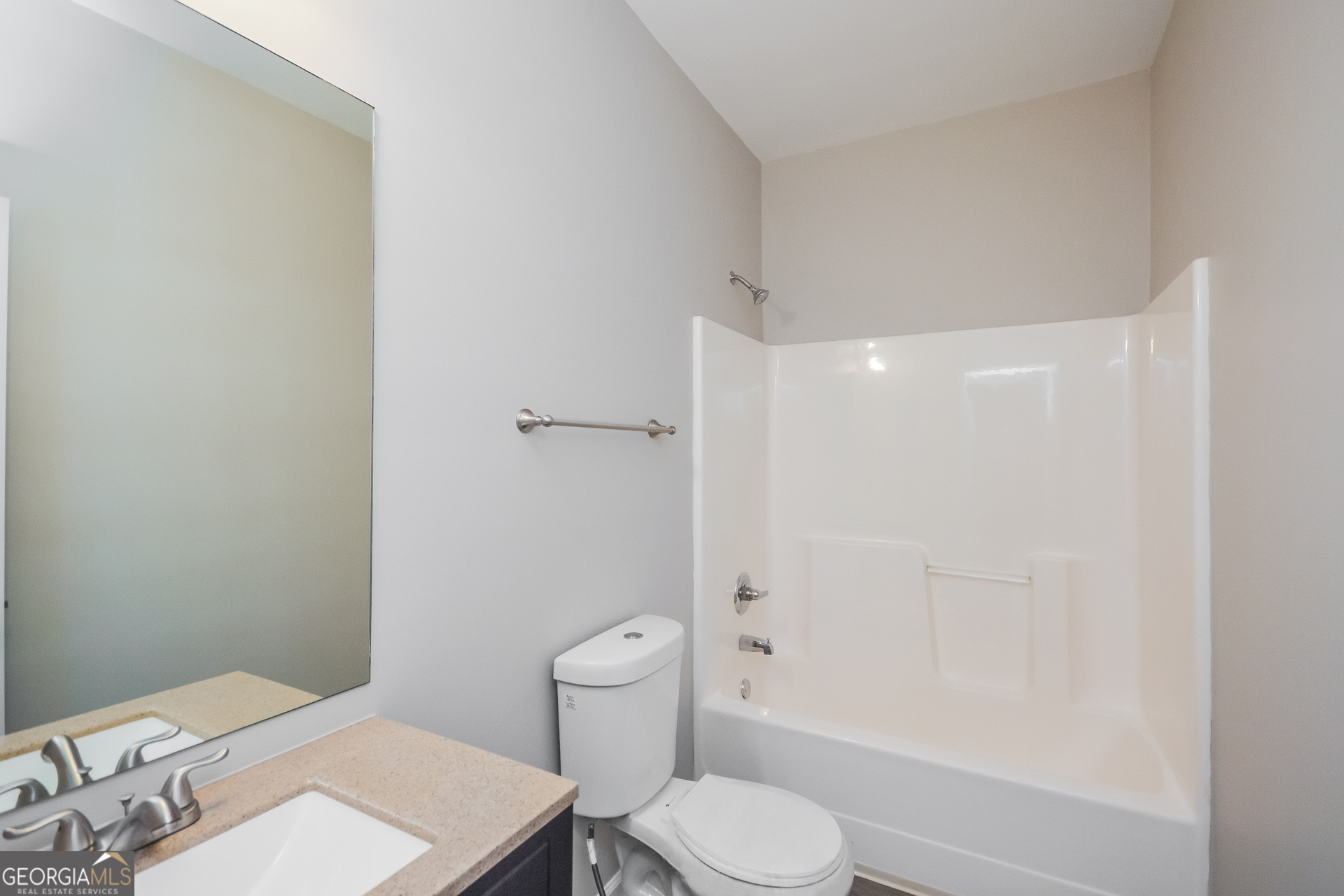 70 Joshua Creek Road Covington, GA 30016 - Photo 14 of 15 a white toilet sitting next to a bathroom sink and vanity