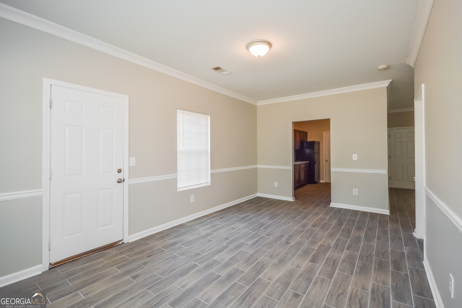 70 Joshua Creek Road Covington, GA 30016 - Photo 5 of 15 a view of an empty room with wooden floor and a window