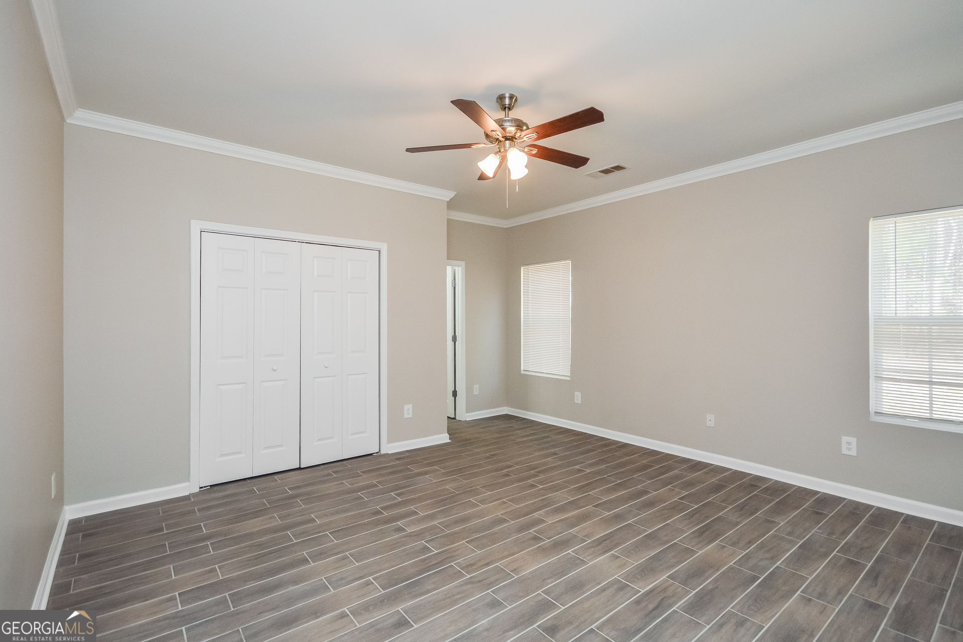 70 Joshua Creek Road Covington, GA 30016 - Photo 8 of 15 a view of an empty room with wooden floor and a window