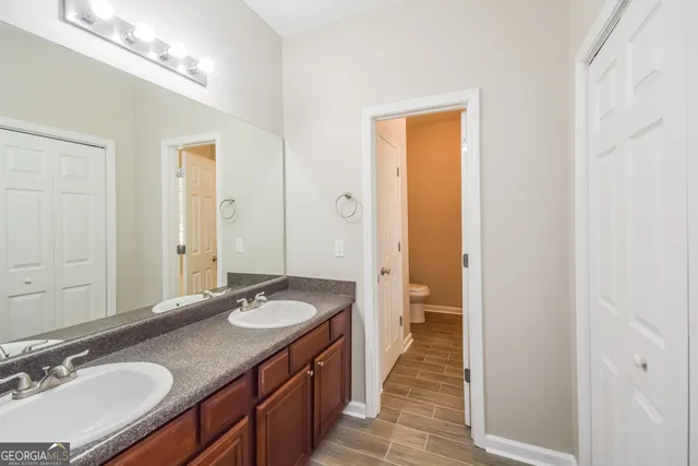 a bathroom with a granite countertop sink and a mirror