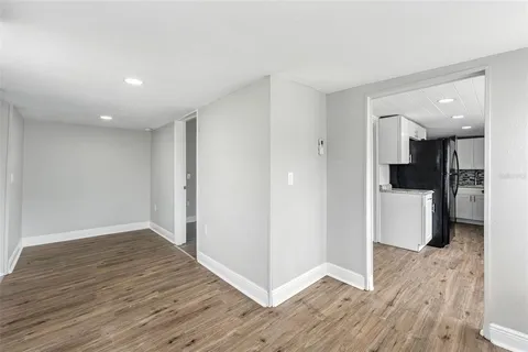 a view of a kitchen with wooden floor and a sink