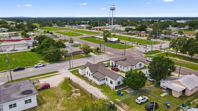 an aerial view of a house with a swimming pool yard and outdoor seating