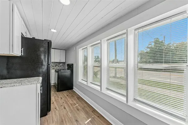a kitchen with a refrigerator and cabinets