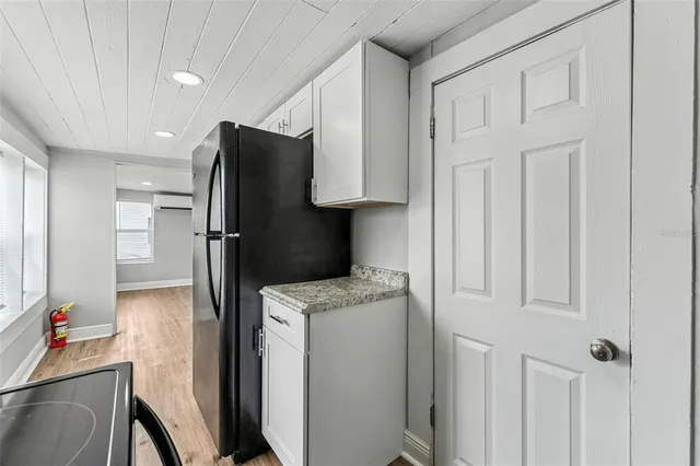 a kitchen with a refrigerator and a sink