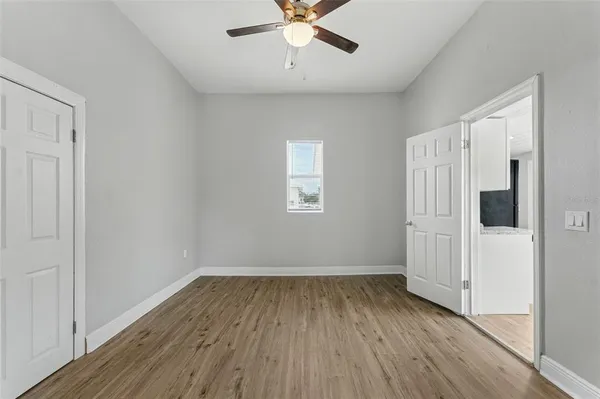 wooden floor in an empty room with a window