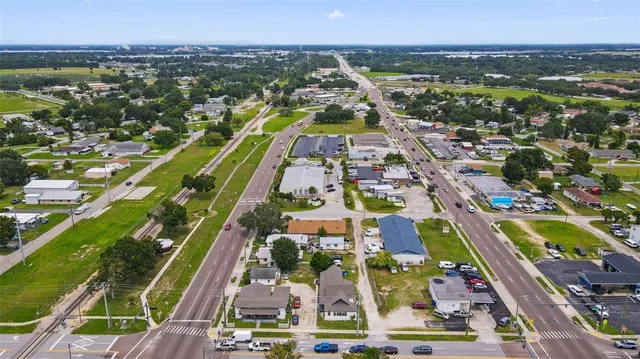 an aerial view of residential houses with outdoor space and swimming pool