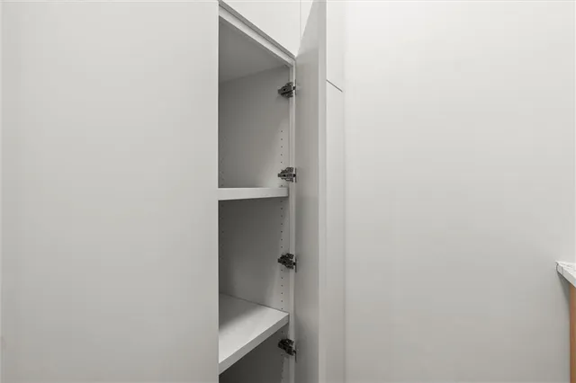 a view of a room with wooden floor and a window