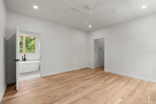 a white toilet sitting next to a shower