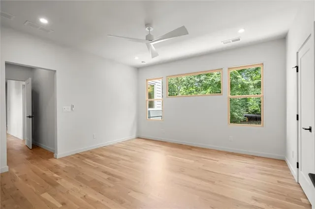 a view of walk in closet with empty racks