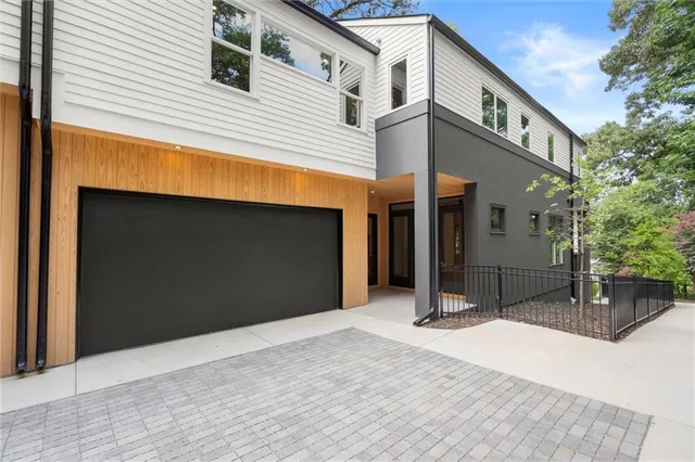a view of an empty room with a window and a kitchen