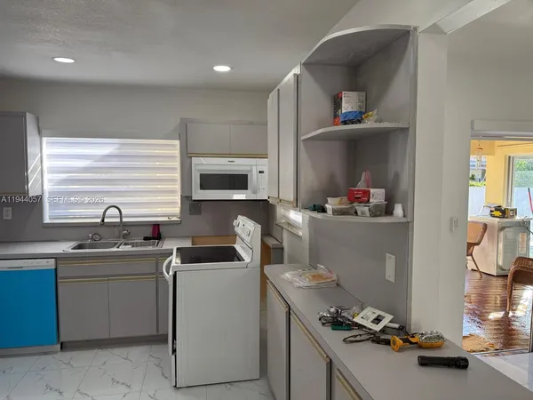 a kitchen with a sink cabinets and appliances