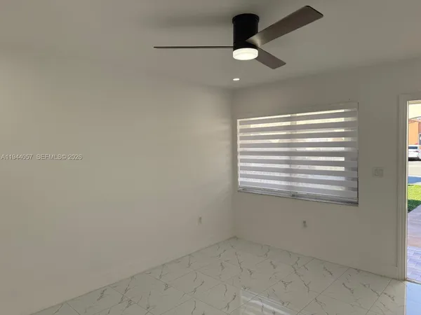 a view of an empty room with a window