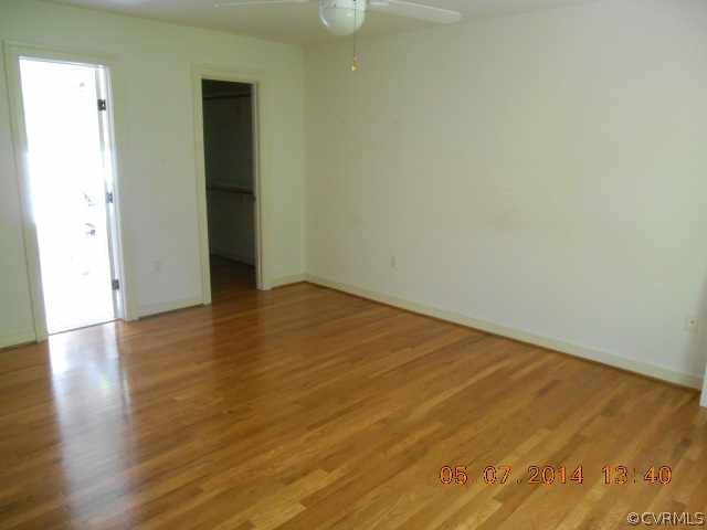 2913 Old Gun Road West Midlothian, VA 23113 - Photo 13 of 24 a view of an empty room with wooden floor and a window