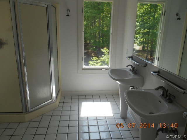 2913 Old Gun Road West Midlothian, VA 23113 - Photo 14 of 24 a bathroom with a sink and a shower