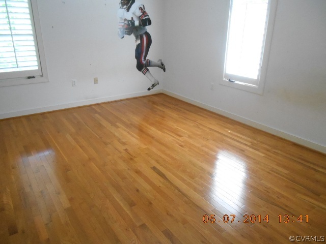 2913 Old Gun Road West Midlothian, VA 23113 - Photo 16 of 24 a view of a room with wooden floor and white walls