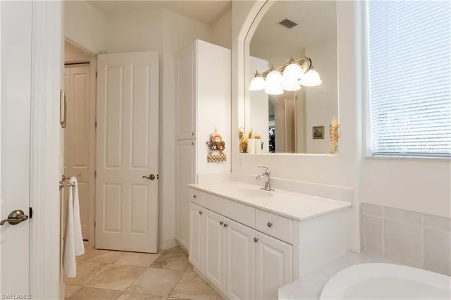 a bathroom with a sink vanity mirror and toilet