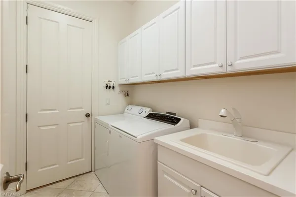 a utility room with sink dryer and washer