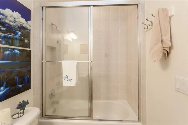 a bathroom with a glass shower door