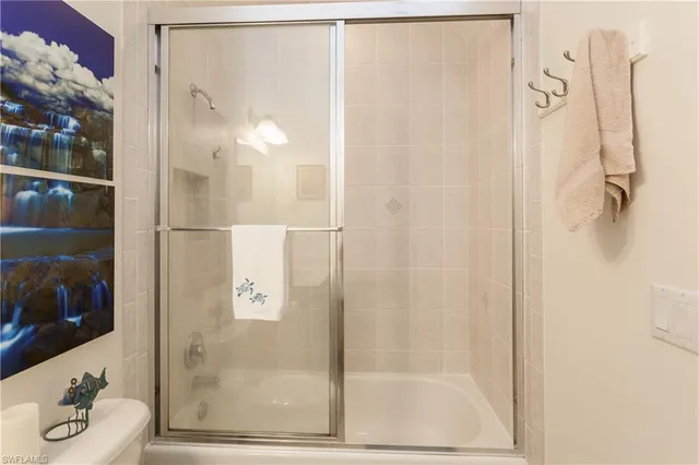 a bathroom with a glass shower door
