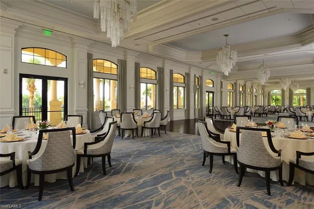 a view of a dining room with furniture and chandelier