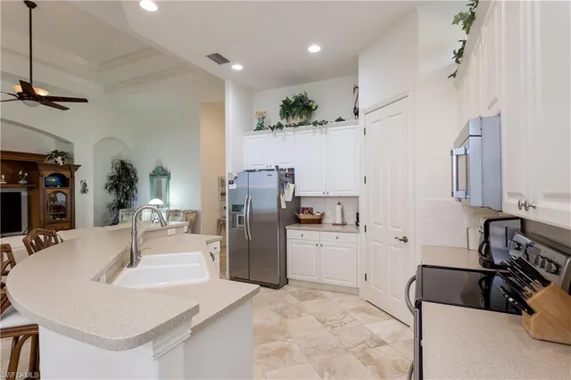 a kitchen with refrigerator and sink