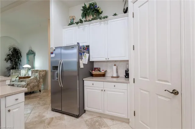 a kitchen with cabinets and stainless steel appliances