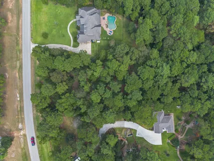 an aerial view of a house with a yard basket ball court