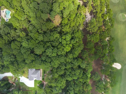 an aerial view of a house with a yard