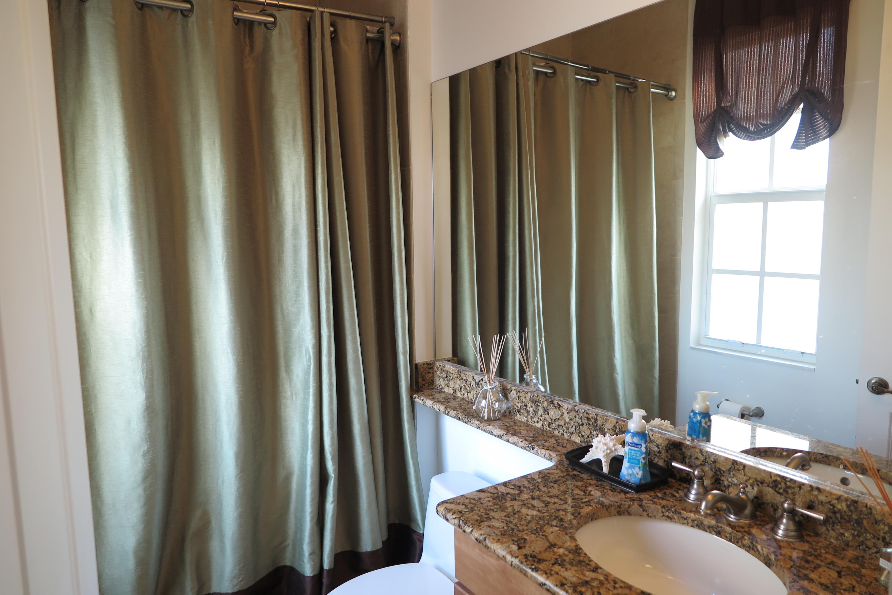 819 Northwest 82nd Place Boca Raton, FL 33487 - Photo 16 of 25 a bathroom with a granite countertop sink and a mirror