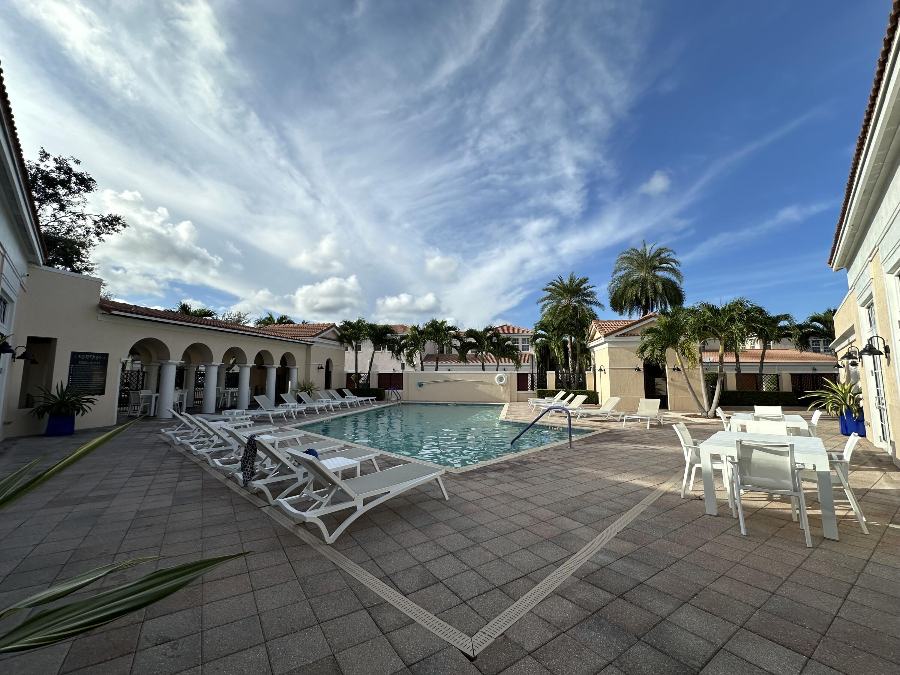 819 Northwest 82nd Place Boca Raton, FL 33487 - Photo 20 of 25 a view of a patio with couches and table and chairs with wooden fence and plants