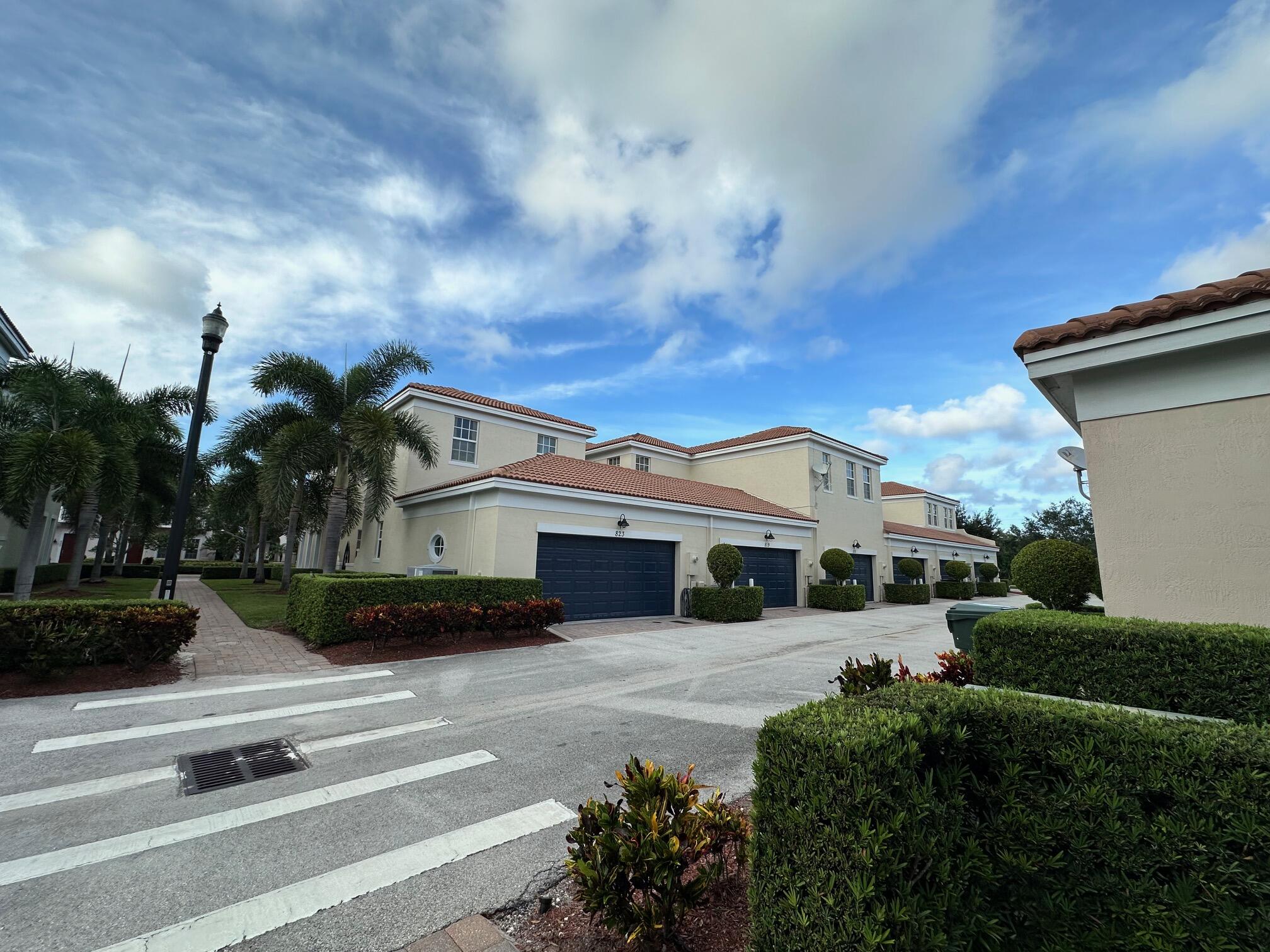 819 Northwest 82nd Place Boca Raton, FL 33487 - Photo 24 of 25 a front view of a house with a garden