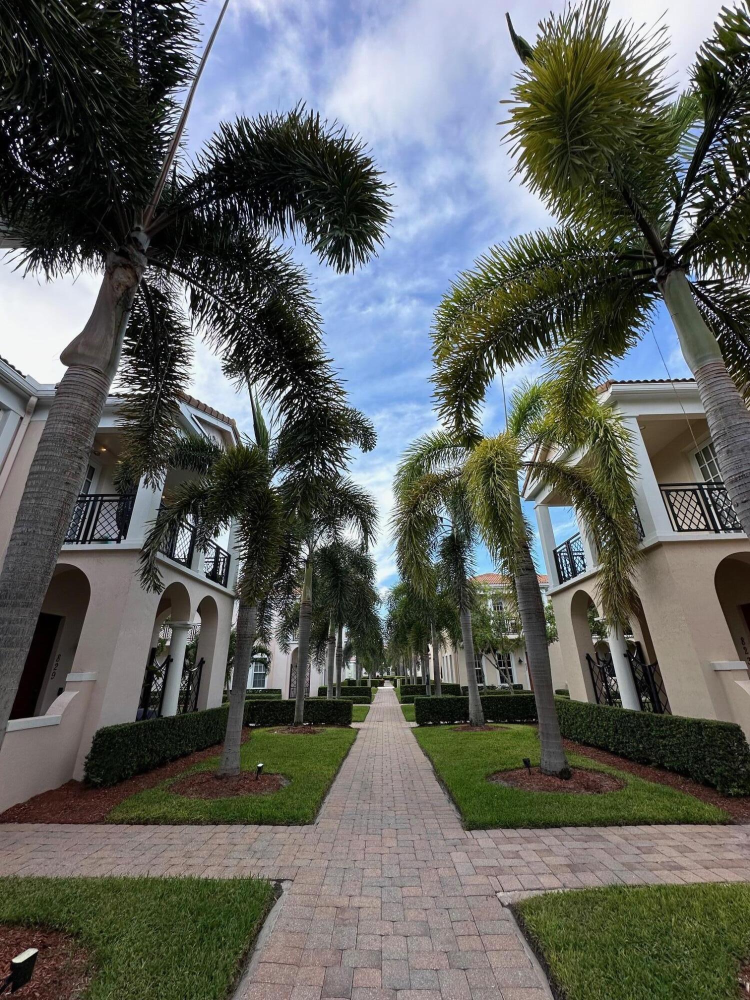 819 Northwest 82nd Place Boca Raton, FL 33487 - Photo 25 of 25 a front view of multi story residential apartment building with yard and green space
