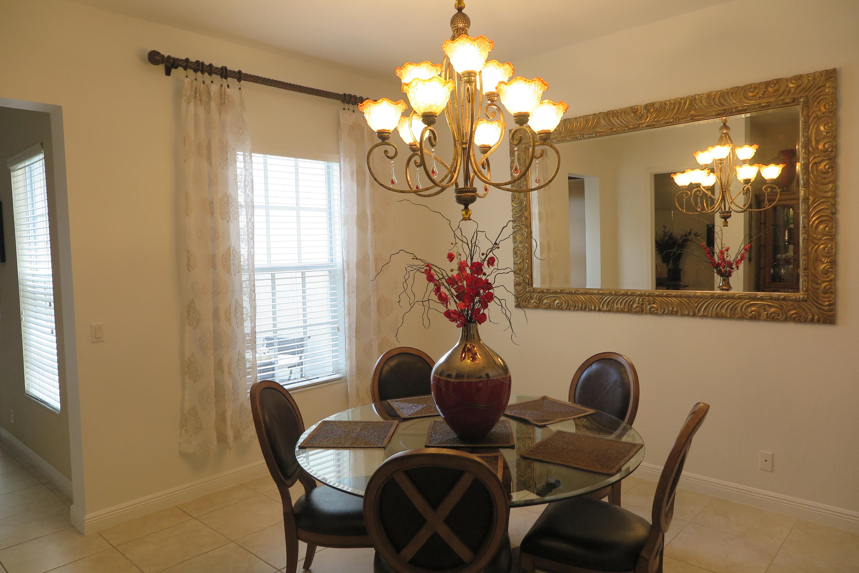 819 Northwest 82nd Place Boca Raton, FL 33487 - Photo 7 of 25 a view of a dining room with furniture and chandelier