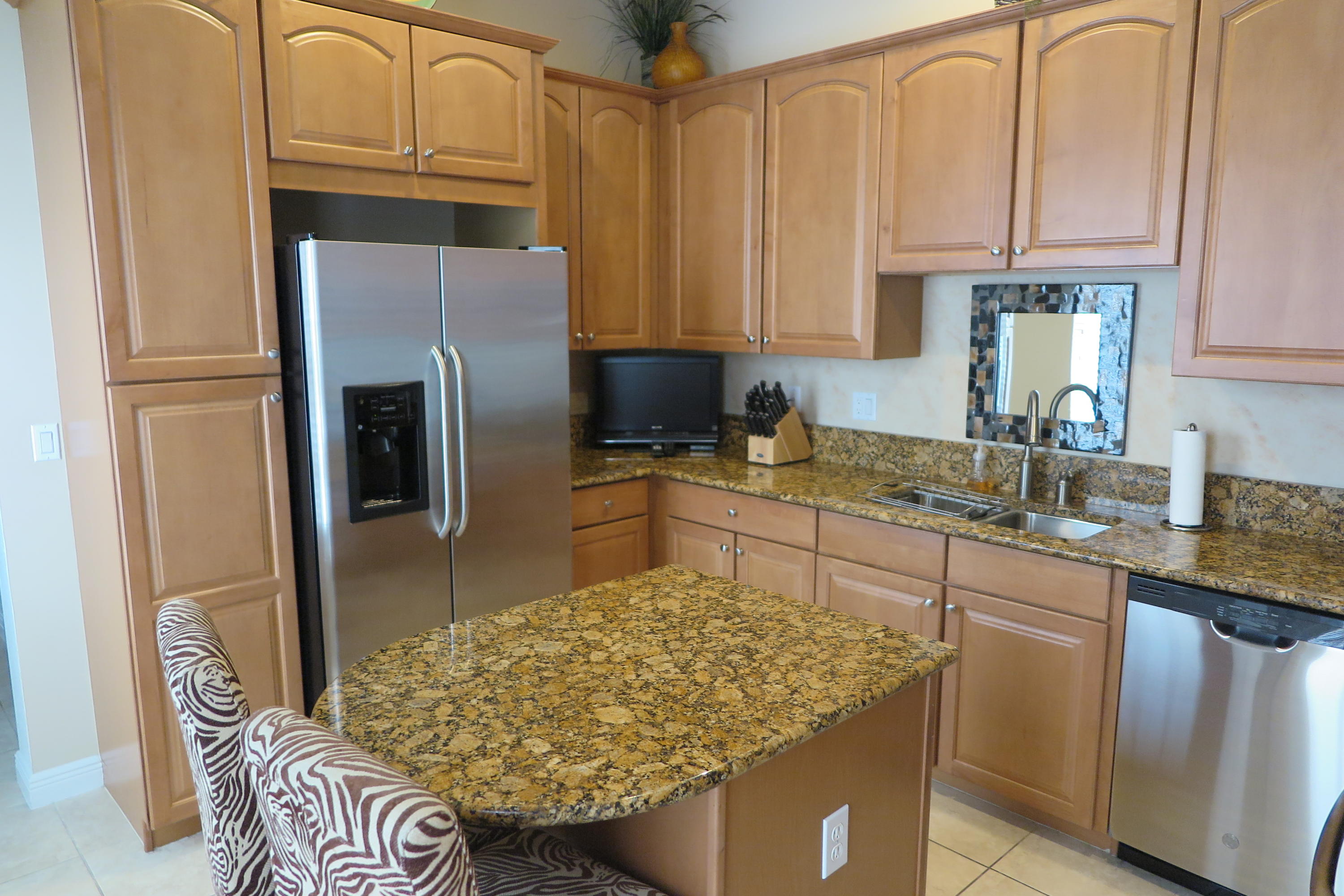 819 Northwest 82nd Place Boca Raton, FL 33487 - Photo 8 of 25 a kitchen with stainless steel appliances granite countertop a refrigerator sink and cabinets