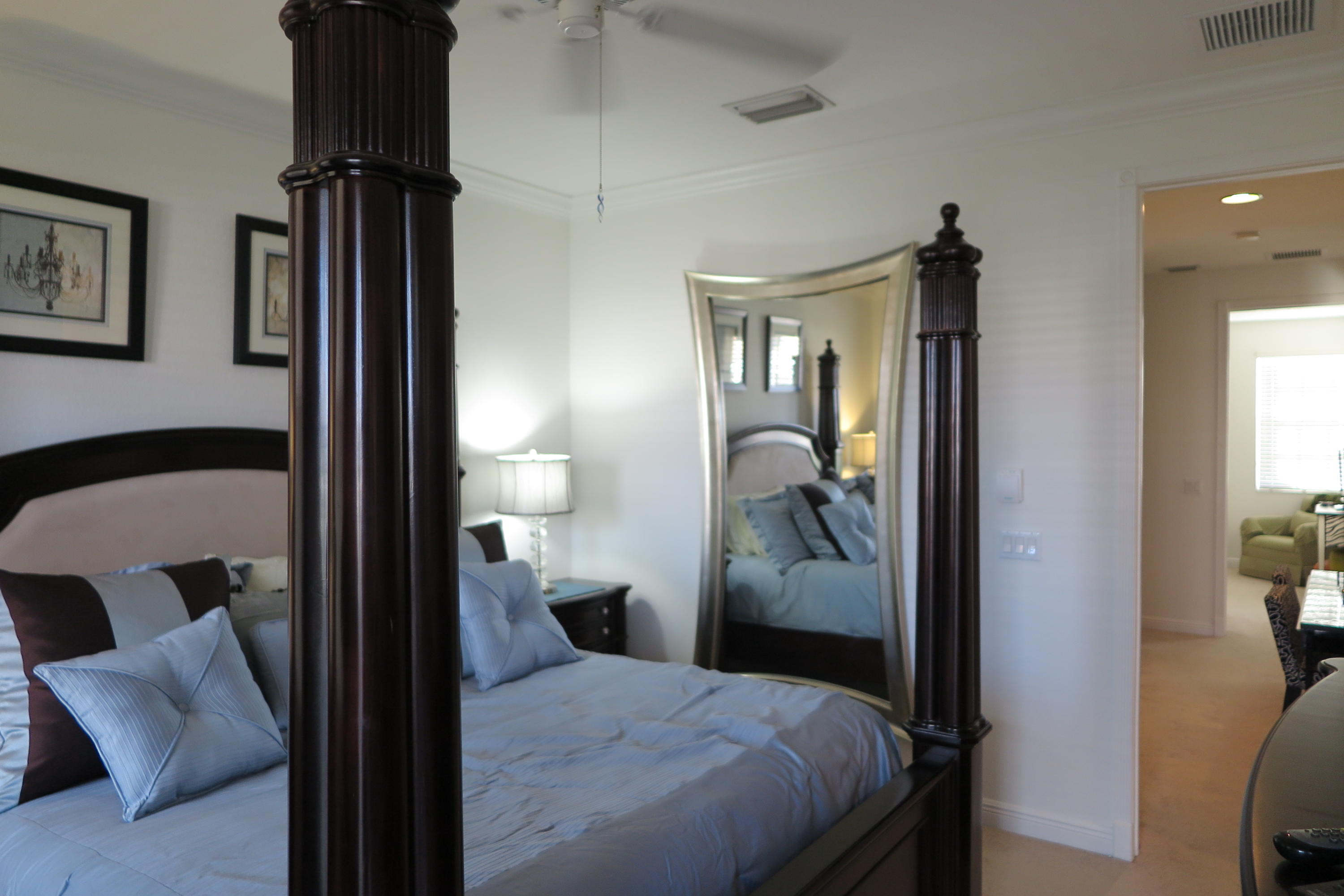 819 Northwest 82nd Place Boca Raton, FL 33487 - Photo 10 of 25 a bedroom with a bed and a mirror