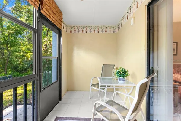 a balcony view with a table and chairs
